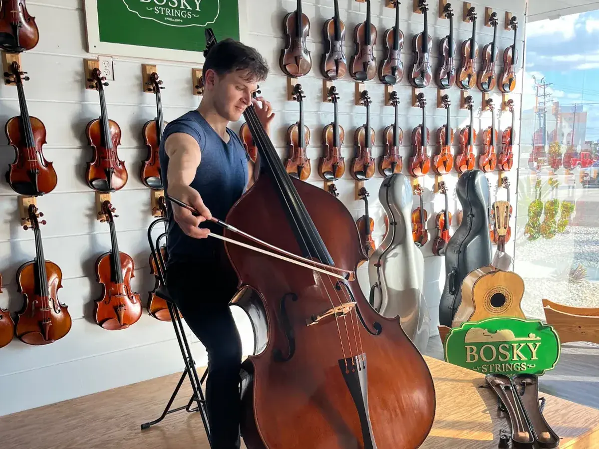 A musician playing a double bass on the stage at Bosky Strings in Edinburg, Texas
